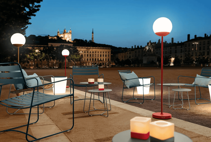 Load image into Gallery viewer, Fermob MOOON! wireless floor lamp, 134 cm tall with a modern moon-inspired design, standing on a living room floor.
