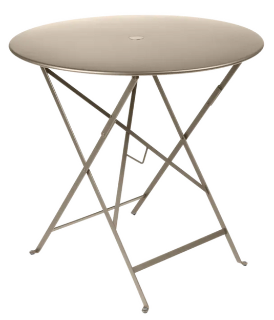 Fermob Nutmeg Beige round outdoor Bistro Table with 77cm diameter, folding metal design for cafe or patio use.