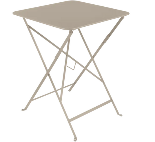 Fermob metal foldable bistro table in nutmeg beige, 57x57 inches, suitable for outdoor cafe or patio seating.