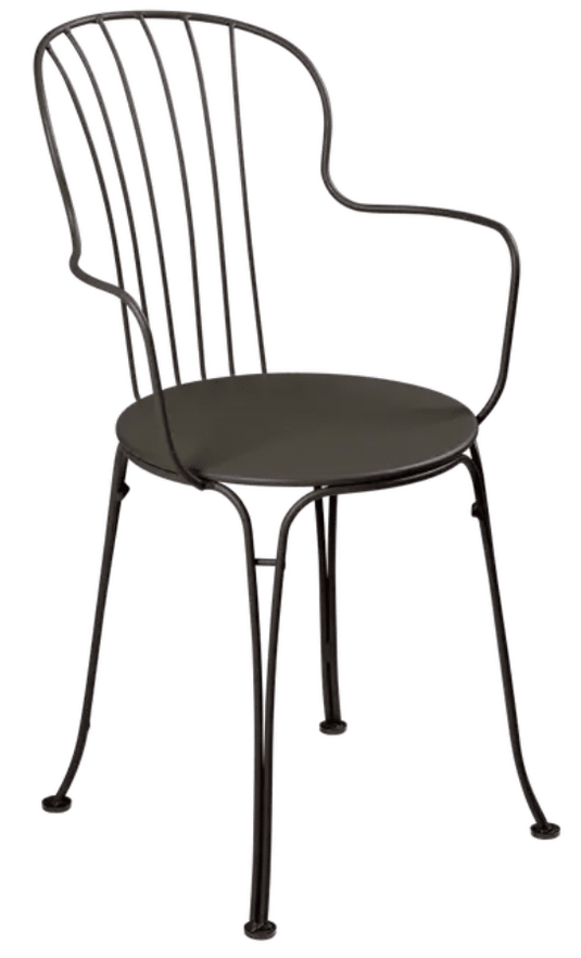Fermob OPÉRA+ outdoor metal armchair with a sleek, modern design, shown in a vibrant yellow color on a patio.