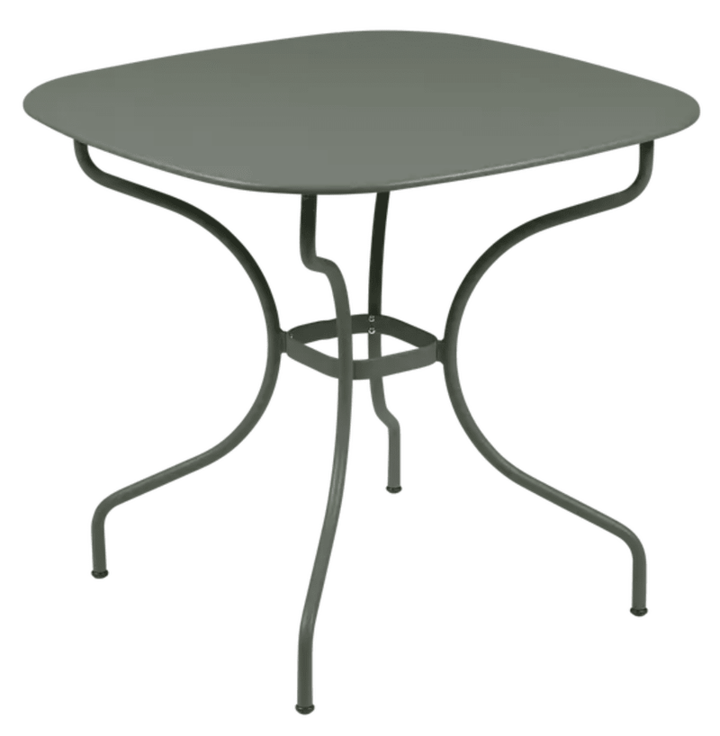 Load image into Gallery viewer, Fermob OPÉRA+ Carronde outdoor metal table, 82x82 cm, shown in a garden setting with a modern design and smooth surface.
