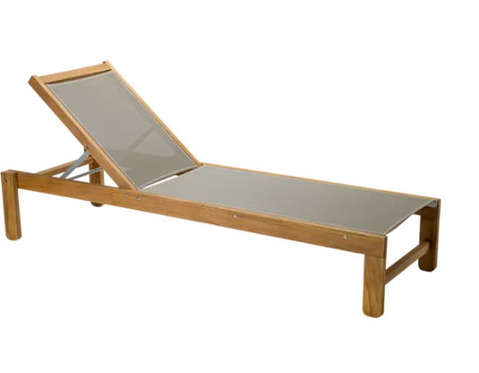 Fermob IBIZA teak outdoor sunlounger with adjustable backrest on a patio, designed for relaxing in the sun.