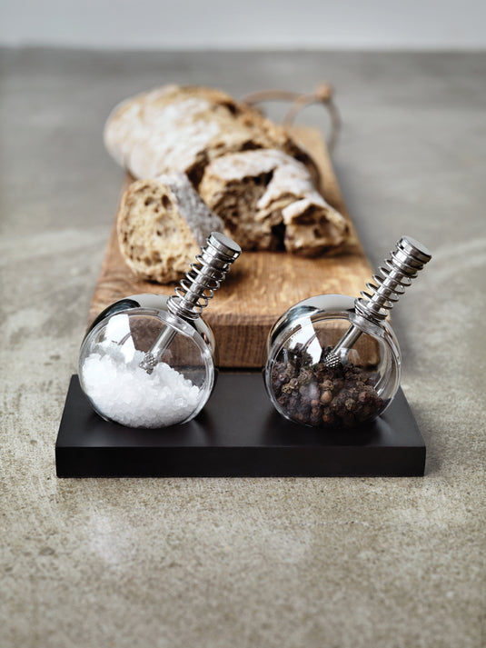 XD Design Planet pepper and salt set featuring round ceramic containers with matching lids for kitchen storage.