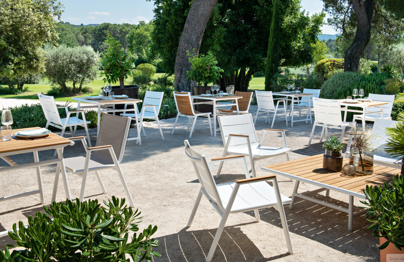 Load image into Gallery viewer, Fermob Pilotis V. low teak and aluminium outdoor table, 104x67.5 cm, with sleek modern design and natural wood finish.
