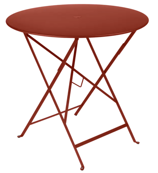 Red ochre Fermob Bistro Table Ø77cm round folding outdoor metal table for café or patio use.