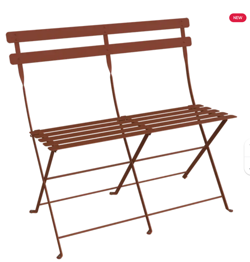 Load image into Gallery viewer, Red Fermob Bistro Two Seater Ottoman folding bench with wooden legs, designed for outdoor seating and versatile use.
