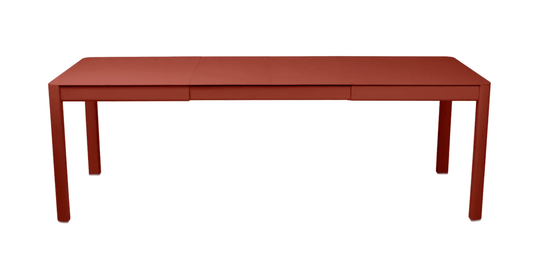 Red Fermob Ribambelle extendable metal table, large 10-seater outdoor dining table, aluminum construction, suitable for hospitality use.
