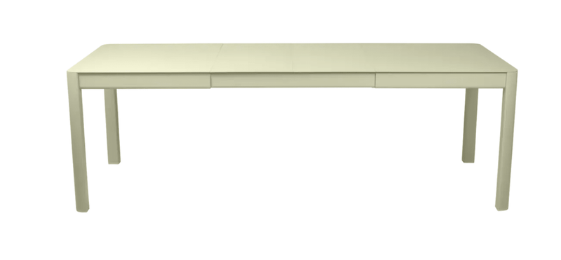 Load image into Gallery viewer, Willow green Fermob Ribambelle extendable metal table set up outdoors, showing its expandable design and 10-seater capacity.

