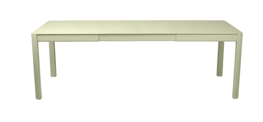 Willow green Fermob Ribambelle extendable metal table set up outdoors, showing its expandable design and 10-seater capacity.