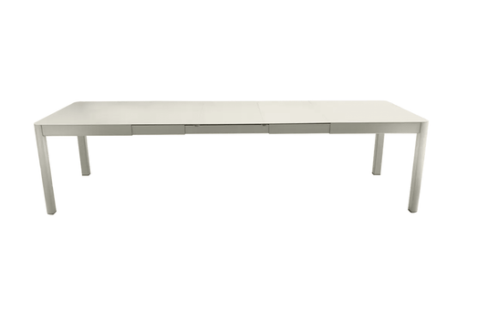Large Fermob Ribambelle XL extendable metal table with 14 seats, ideal for hospitality and large gatherings.
