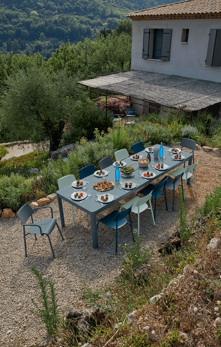 Load image into Gallery viewer, Large Fermob Ribambelle XL extendable metal table with 14 seats, ideal for hospitality and large gatherings.
