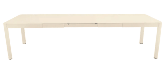 Large Fermob Ribambelle XL extendable metal table in latte beige, 14-seater, perfect for hospitality or large gatherings.