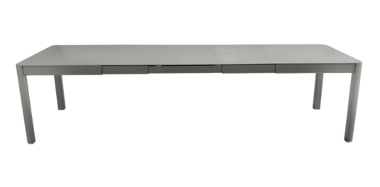 Fermob Ribambelle XL extendable metal dining table in rosemary color, large 14-seater hospitality furniture for gatherings.