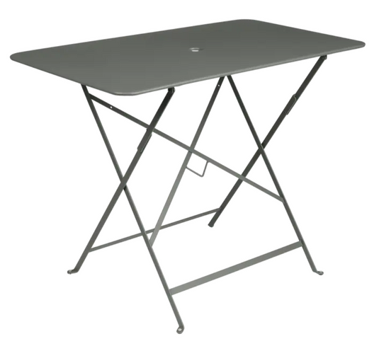 Fermob metal foldable bistro table measuring 97x57 cm in muted green, ideal for outdoor café or patio seating for four.