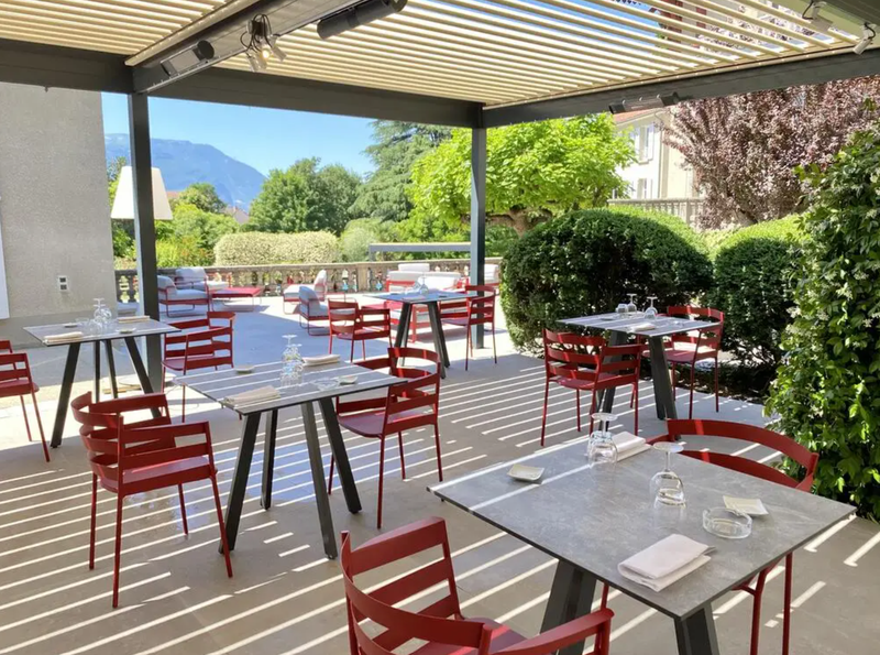 Load image into Gallery viewer, Fermob RYTHMIC outdoor armchair with a woven design and metal frame, ideal for stylish outdoor seating.
