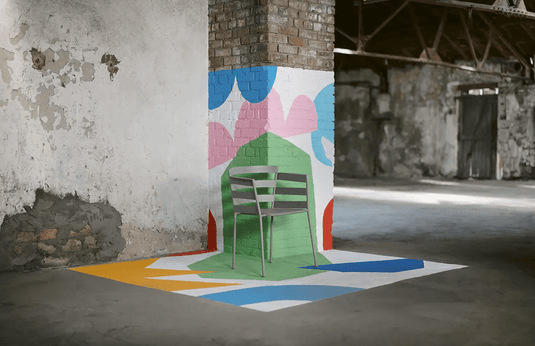 Fermob RYTHMIC outdoor armchair with a modern design, featuring curved metal frame and colorful seat cushion.