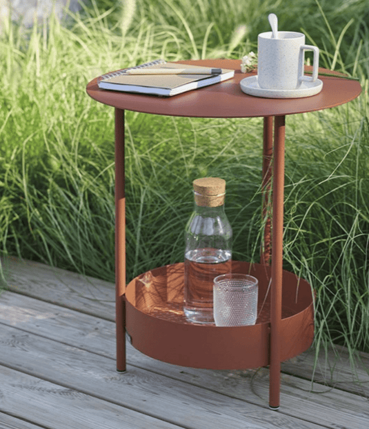 Fermob Salsa pedestal side table with round top and curved pedestal base, suitable for outdoor furniture setting.
