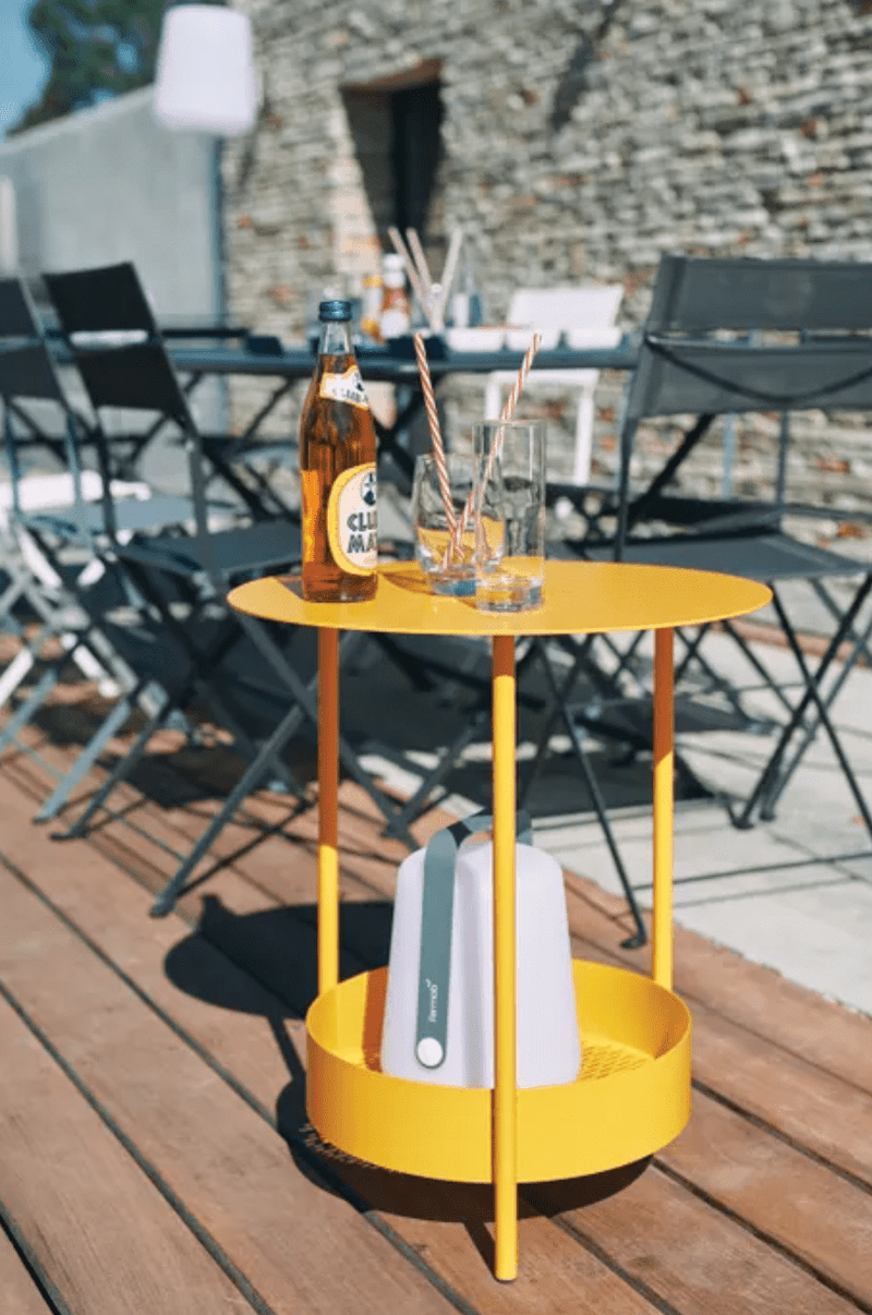 Load image into Gallery viewer, Fermob Salsa pedestal side table with a round top and pedestal base, suitable for outdoor use in a modern patio setting.
