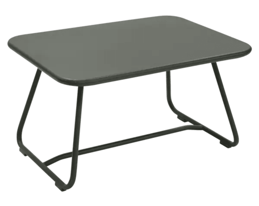 Fermob Sixties low outdoor table with 76 x 55.5cm round tabletop, suitable for patio or garden seating areas.