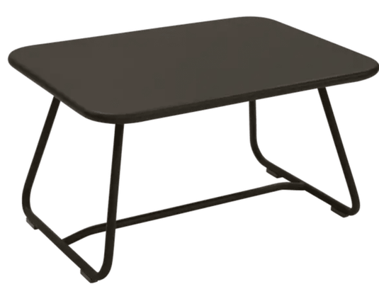 Fermob Sixties Low Outdoor Table in vibrant color, measuring 76x55.5cm, suitable for patio or garden seating areas.