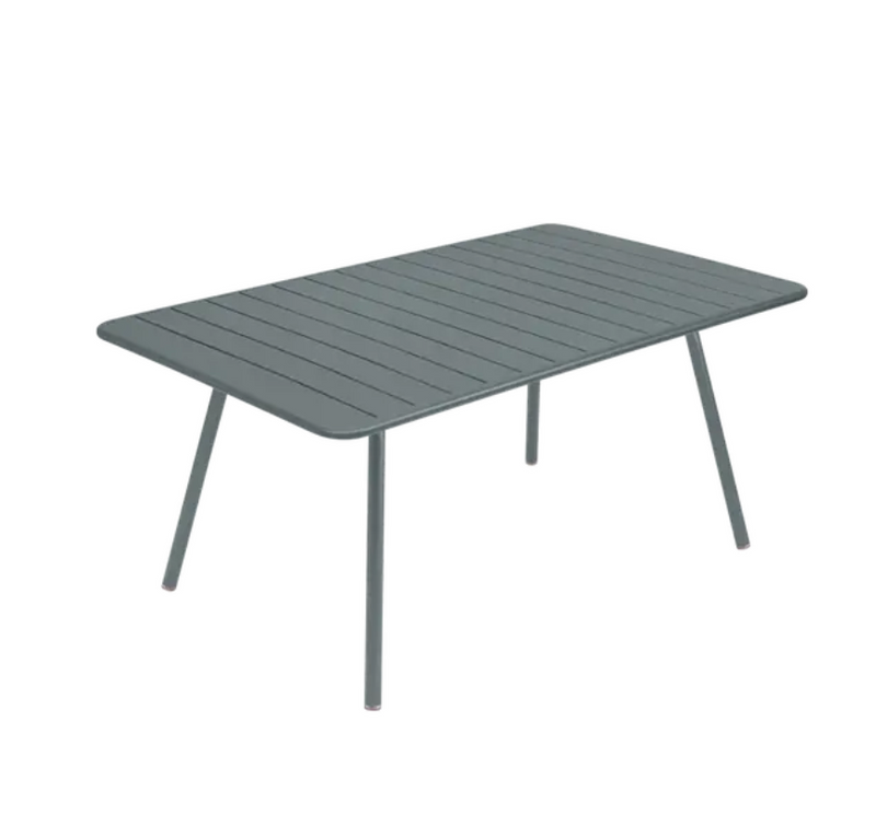 Load image into Gallery viewer, Storm grey Fermob Luxembourg metal outdoor table measuring 165 x 100 cm, displayed in a garden setting.
