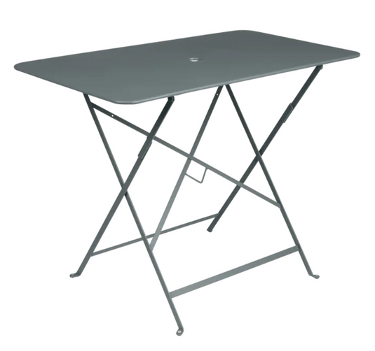 Fermob storm grey metal foldable bistro table, rectangular 97x57 cm, outdoor cafe dining setup with four chairs.