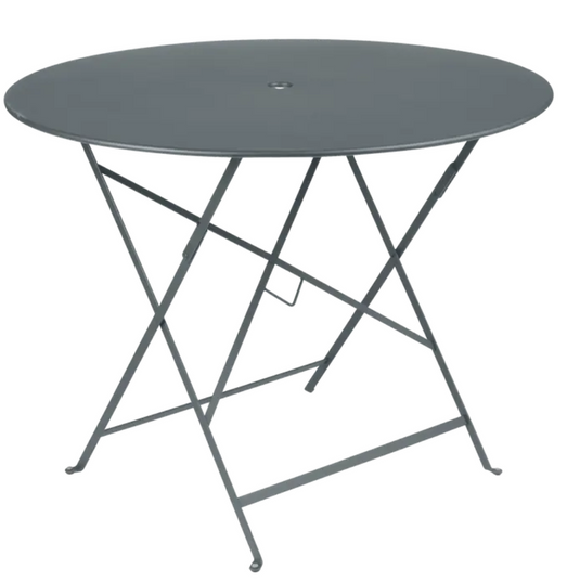 Storm grey Fermob round bistro table with a steel frame, perfect for restaurant terrace or outdoor dining setups.