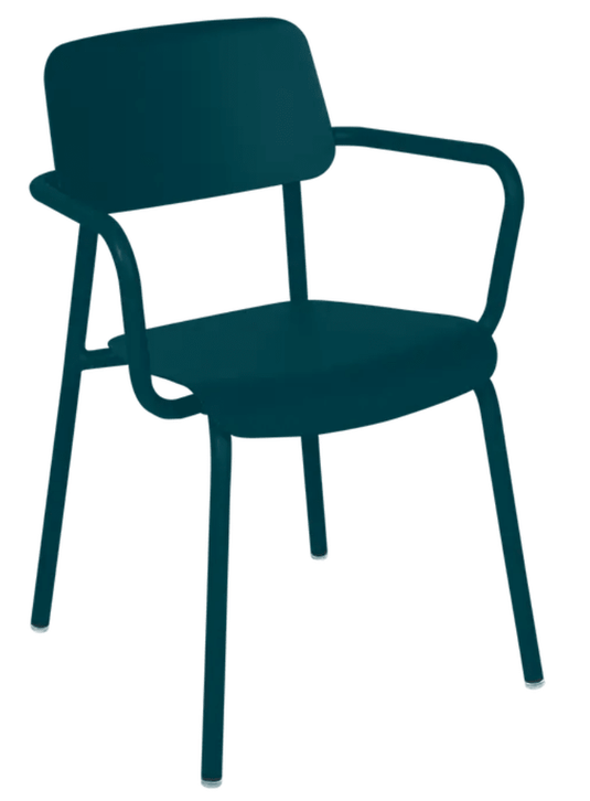Fermob Studie armchair, stackable indoor dining and office chair with a modern design, shown in a home or office setting.
