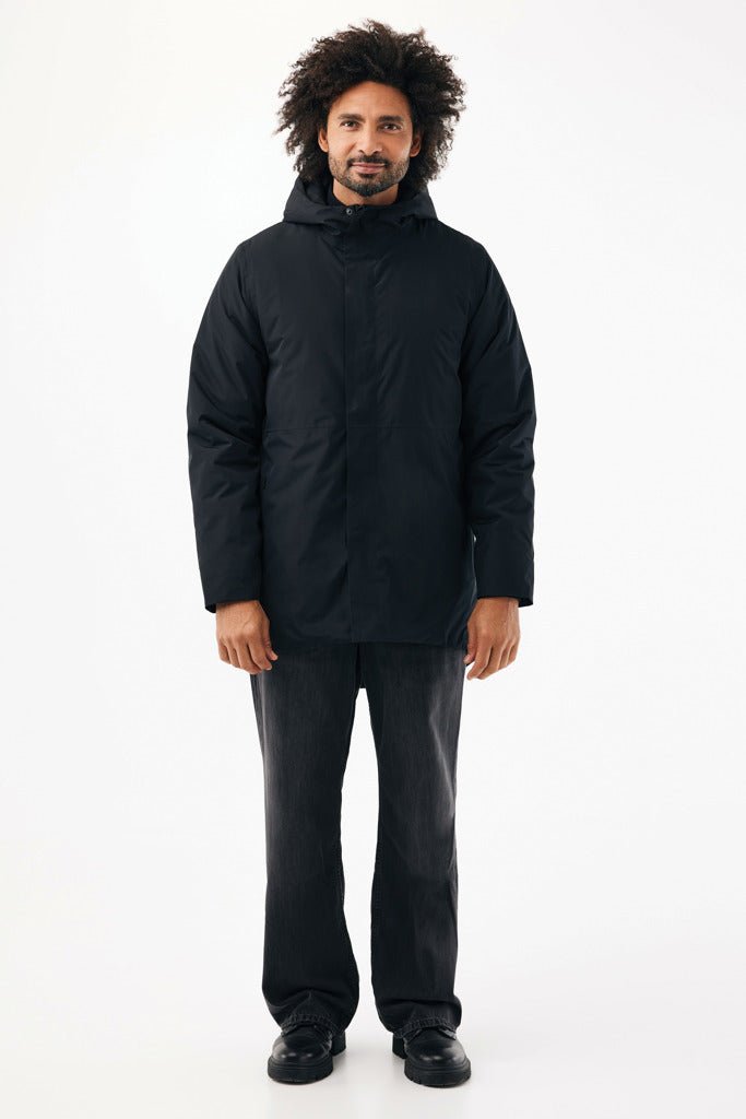 Load image into Gallery viewer, iqoniq Thelon recycled polyester parka with custom wood design, black textile, showcasing eco-friendly, warm outerwear.
