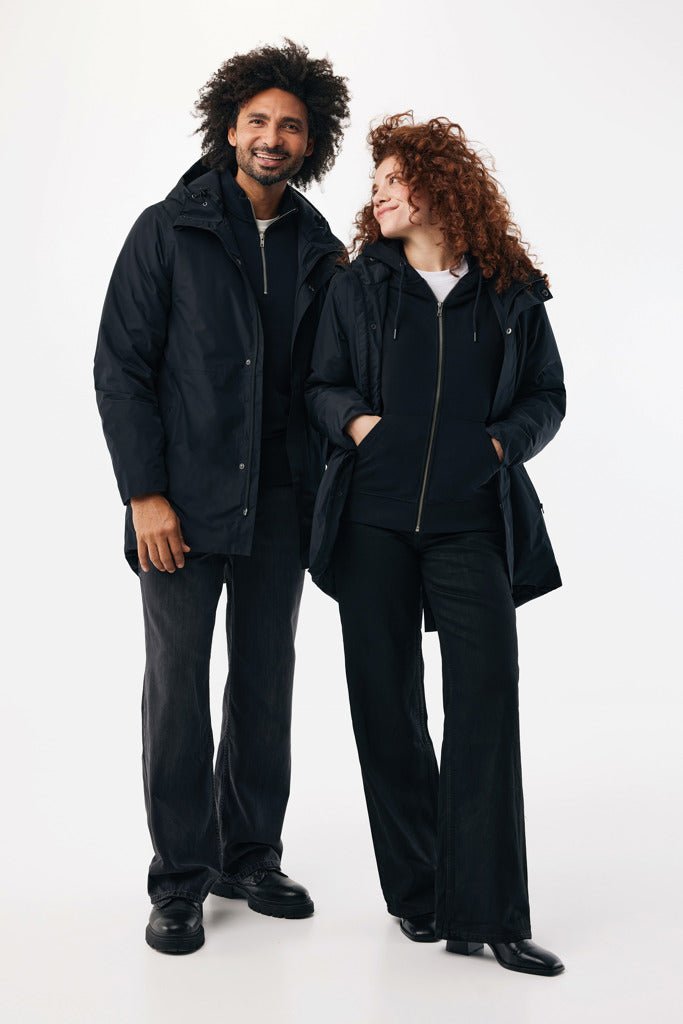 Load image into Gallery viewer, Thelon recycled polyester parka by iqoniq, black textile with a custom wood design, showcasing a stylish, eco-friendly outerwear piece.
