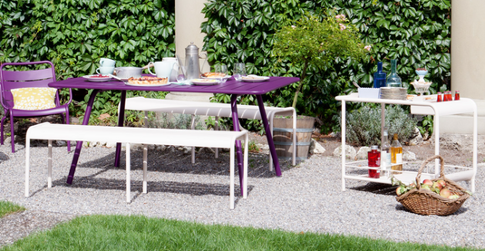 Fermob Luxembourg side bar trolley with wheels, designed for restaurant terrace drinks service, featuring a stylish table with mobile convenience.